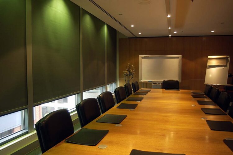 Indoor blackout blinds for conference room with black chairs