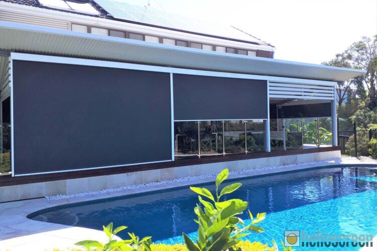 Outdoor blinds providing shade for windows with view of a pool