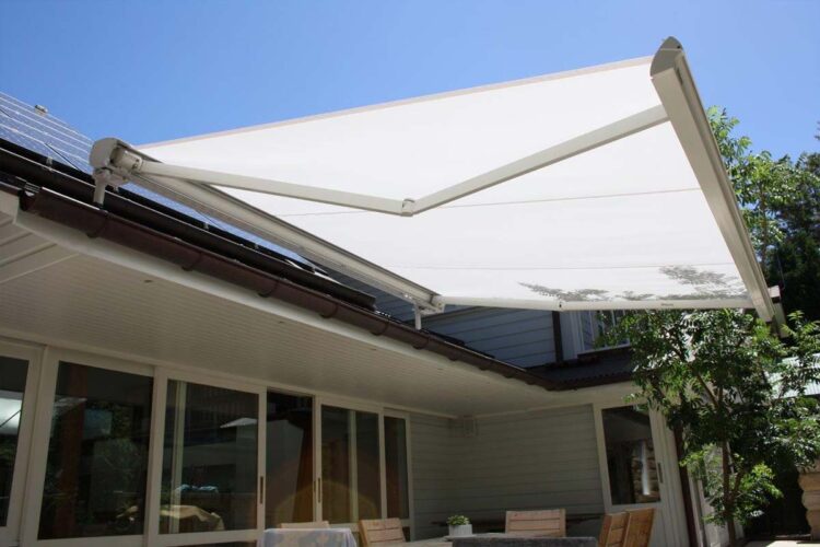 White retractable awning adding shade for outdoor area