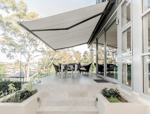 White retractable awning for modern outdoor seating area