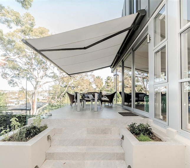 White retractable awning for modern outdoor seating area