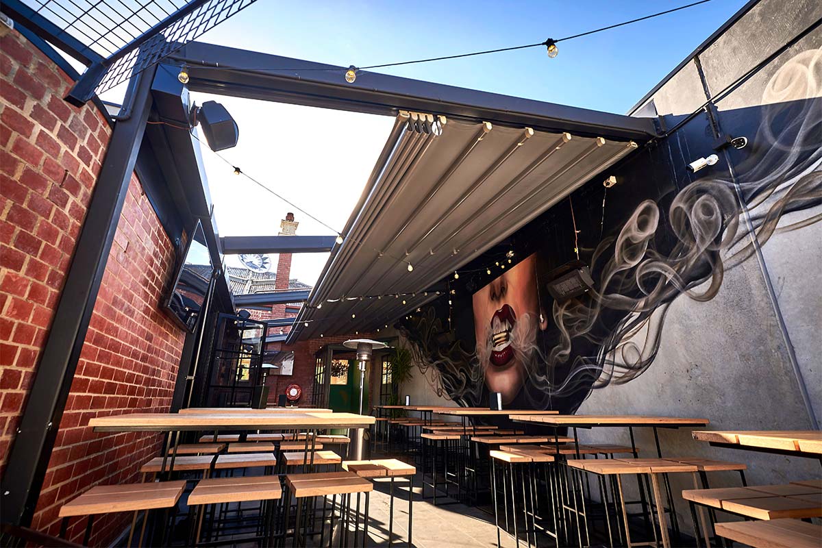 Retractable roof system in bar with graffiti wall
