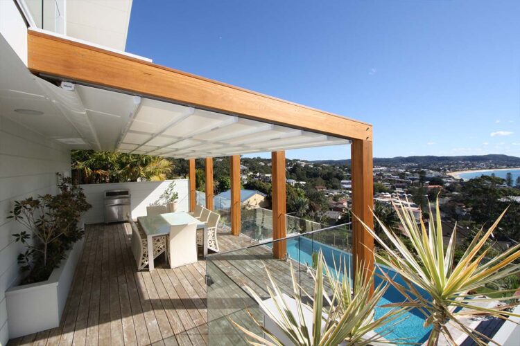 Retractable roof system for modern veranda with view of a pool