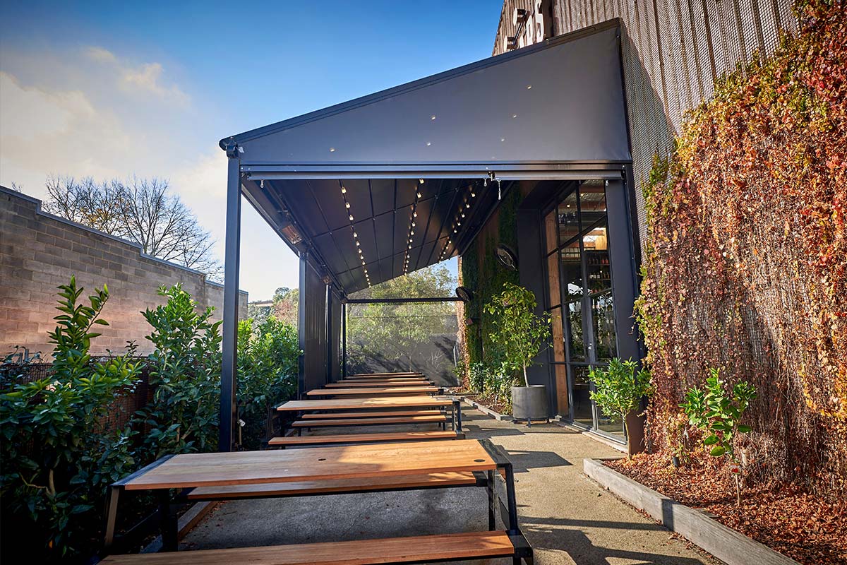 Retractable roof above outdoor seating area