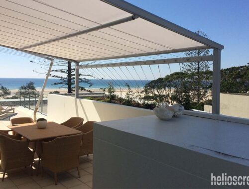 Retractable sunroof adding shade for seating area with view of beach